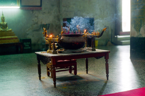 Incense and candles offered in a temple in Ayutthaya