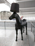 A horse wearing a lamp shade. Of course.