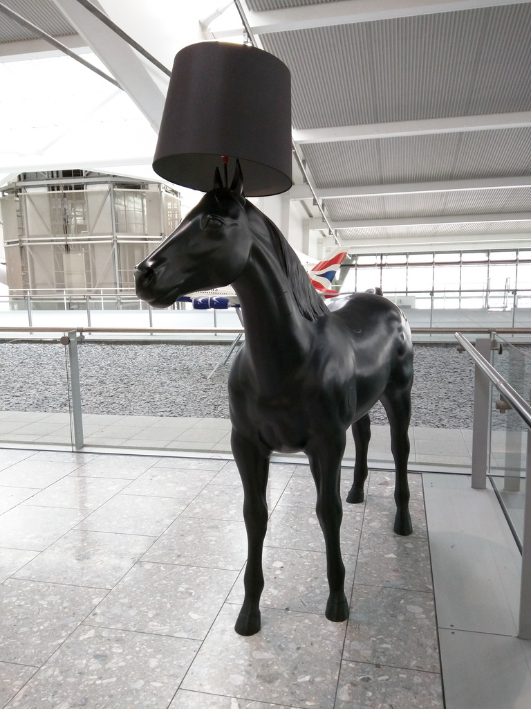 A horse wearing a lamp shade. Of course.