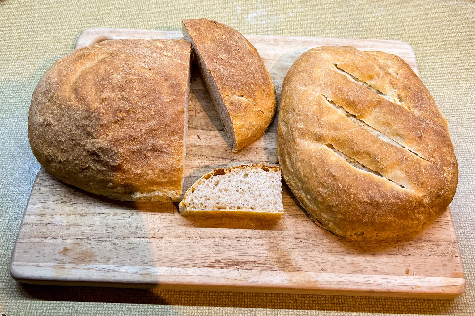 Two loaves of sourdough bread, a bit deflated perhaps bit nice and brown.