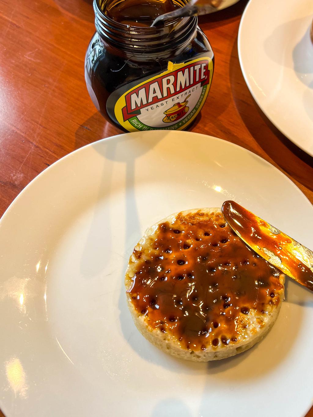A hot-off-the-stove crumpet smeared with butter and marmite