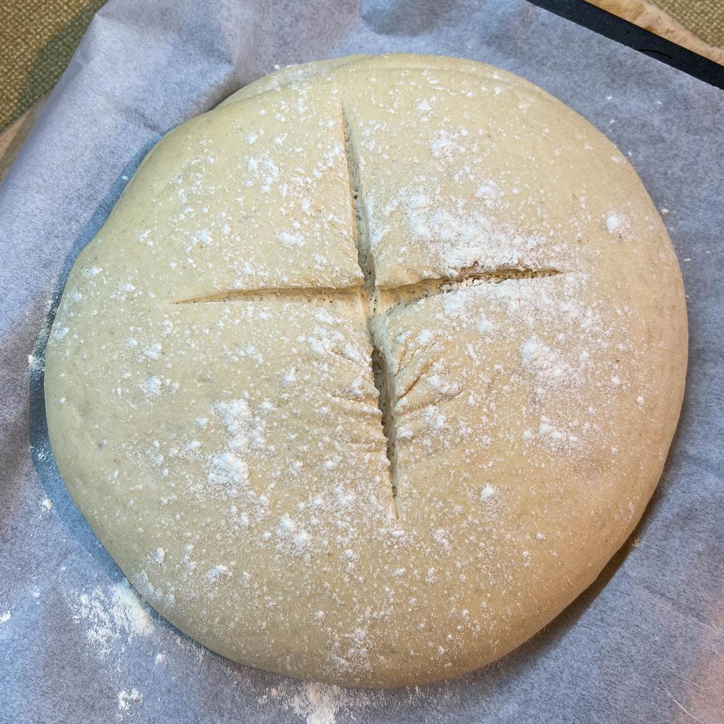 The dough for a plain, white loaf of bread dusted with flour and ready to go in the oven.