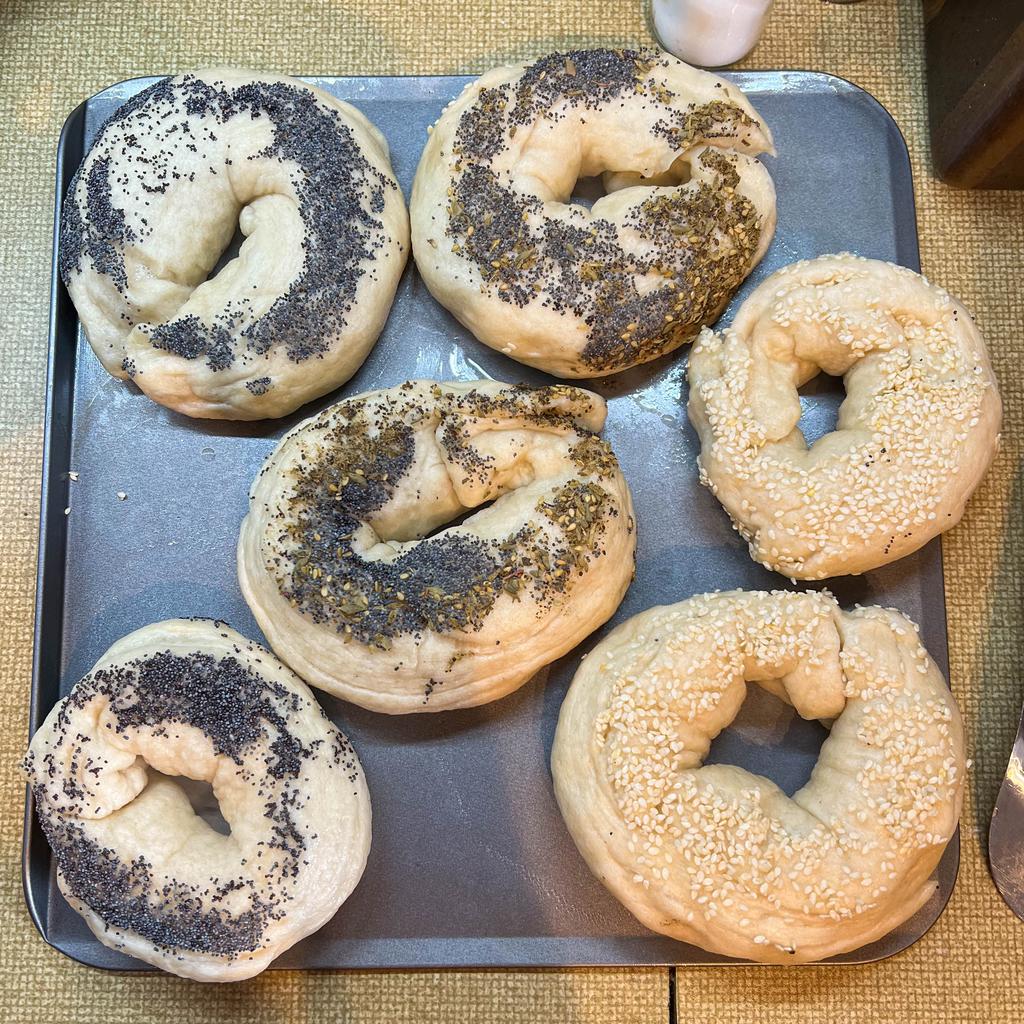 Six bagels boiled and dipped variously in poppy seeds, sesame seeds, and a mixture of za'atar and poppy seeds