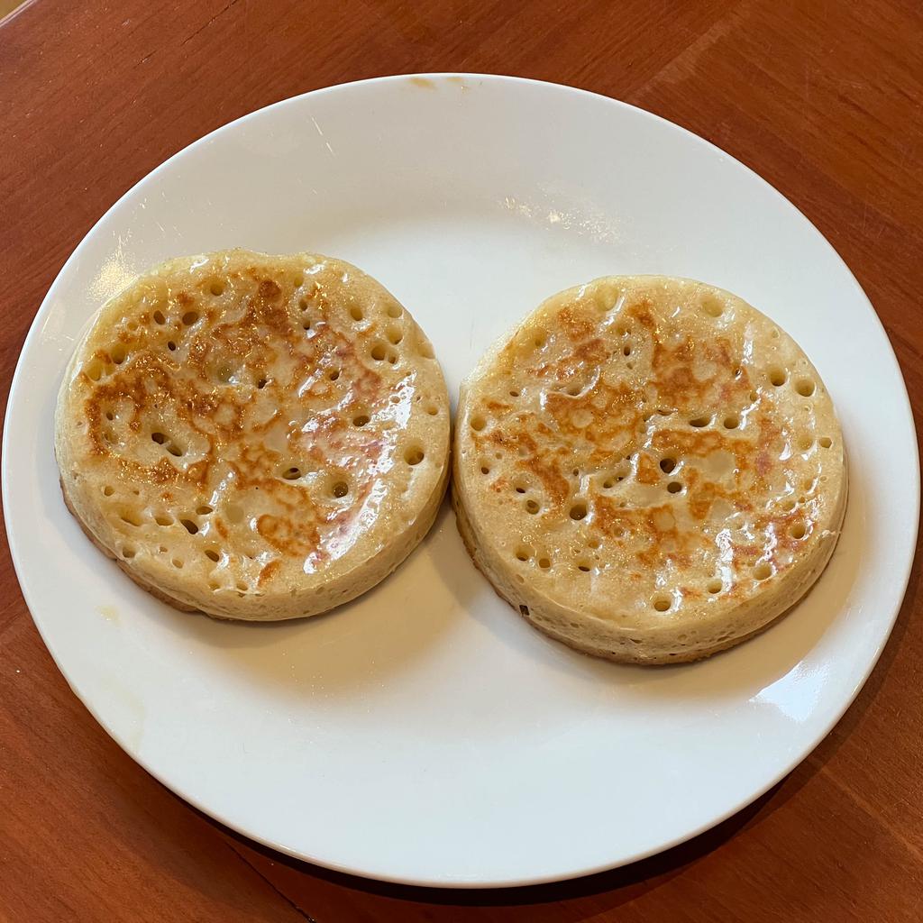 Two buttered crumpts on a plate