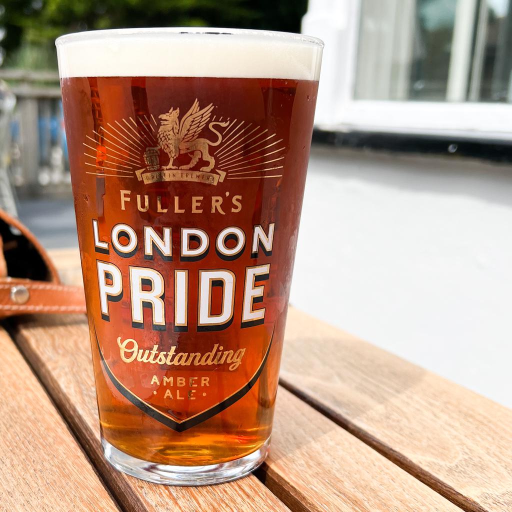 A pint of Fuller’s London Pride on a sunlit patio table